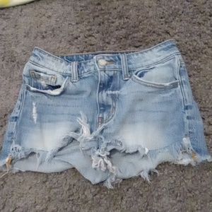 Blue shorts that are ripped from The Buckle.